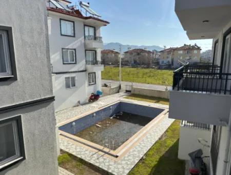 1 1 55M2 Brandneue Wohnung Zum Verkauf In Einem Komplex Mit Pool In Der Nähe Des Ortaca-Zentrums.